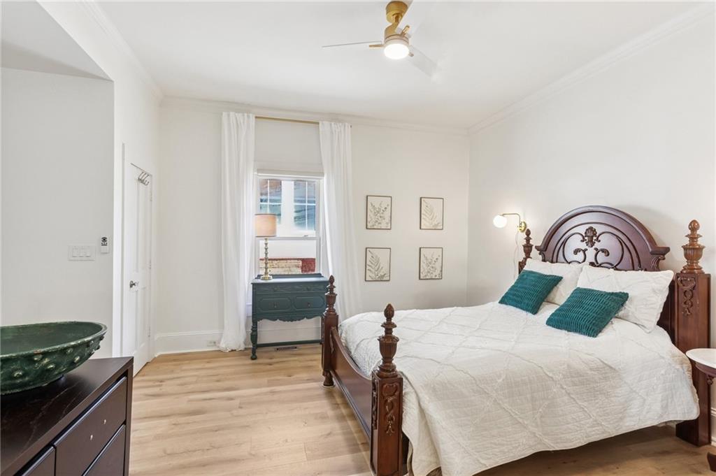 29 Sessions Street Northwest Marietta, GA 30060 - Photo 17 of 39 a bedroom with a bed and a dresser with wooden floor