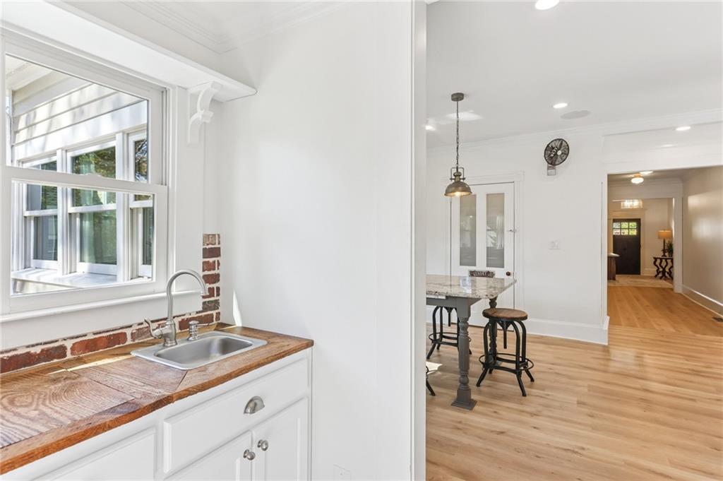 29 Sessions Street Northwest Marietta, GA 30060 - Photo 21 of 39 a kitchen with a sink cabinets and dining table