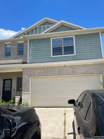 a front view of a house with parking area