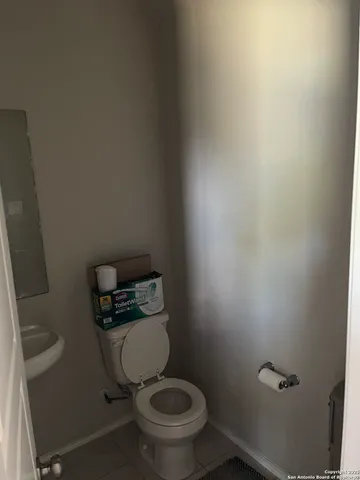 a white toilet sitting in a bathroom