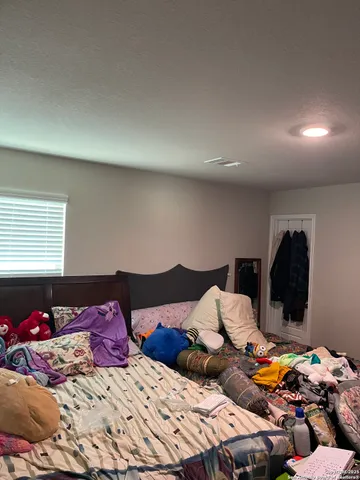 a bedroom with two beds and a chandelier