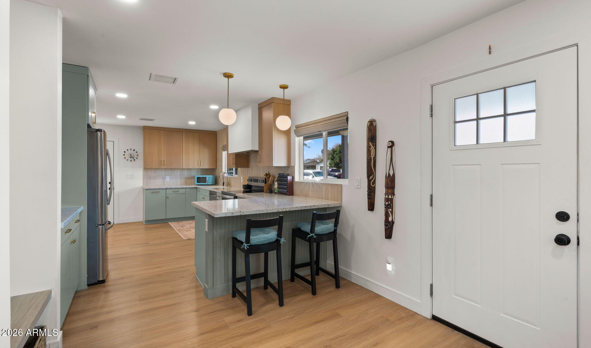 2115 North Normal Avenue Tempe, AZ 85288 - Photo 3 of 38 a kitchen with stainless steel appliances granite countertop a white refrigerator a sink dishwasher and a dining table with wooden floor
