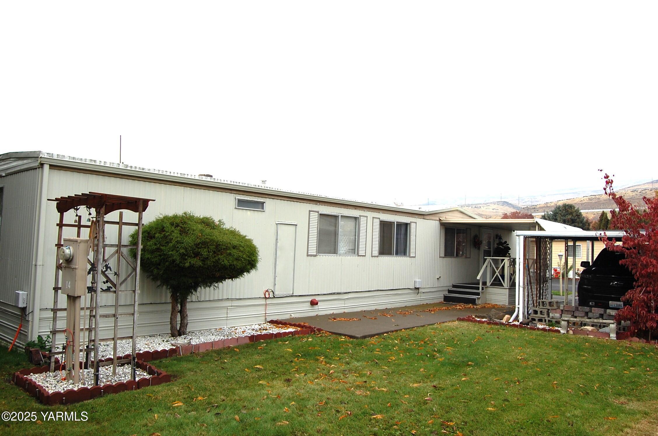 2205 Butterfield Road, Unit 14 Yakima, WA 98901 - Photo 2 of 13 a front view of a house with a yard