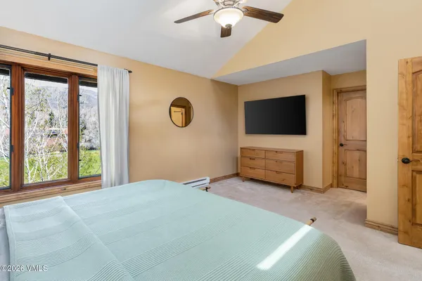 a bedroom with furniture and a large window