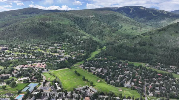 a view of a lush green hillside and houses