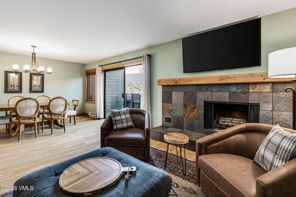 a living room with furniture and a fireplace