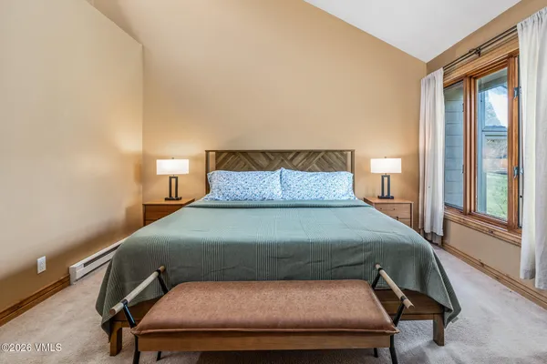 a bedroom with a bed and windows