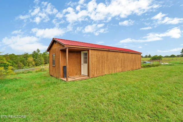 a view of a backyard with a small cabin