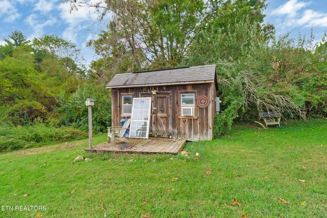 a view of a house with backyard and sitting area