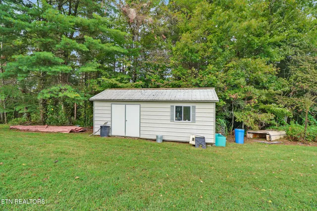 a view of a house with yard and a garden
