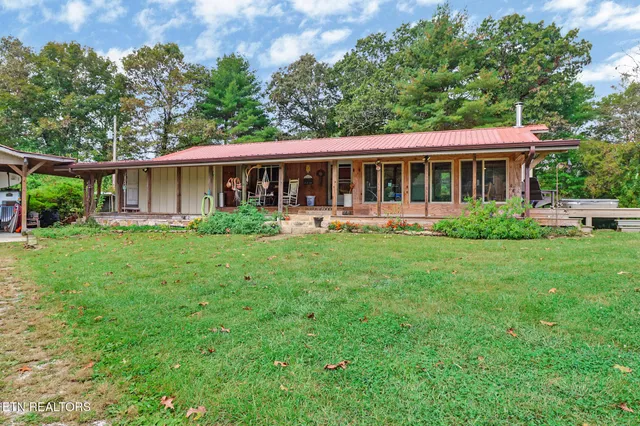 a front view of house with yard and green space