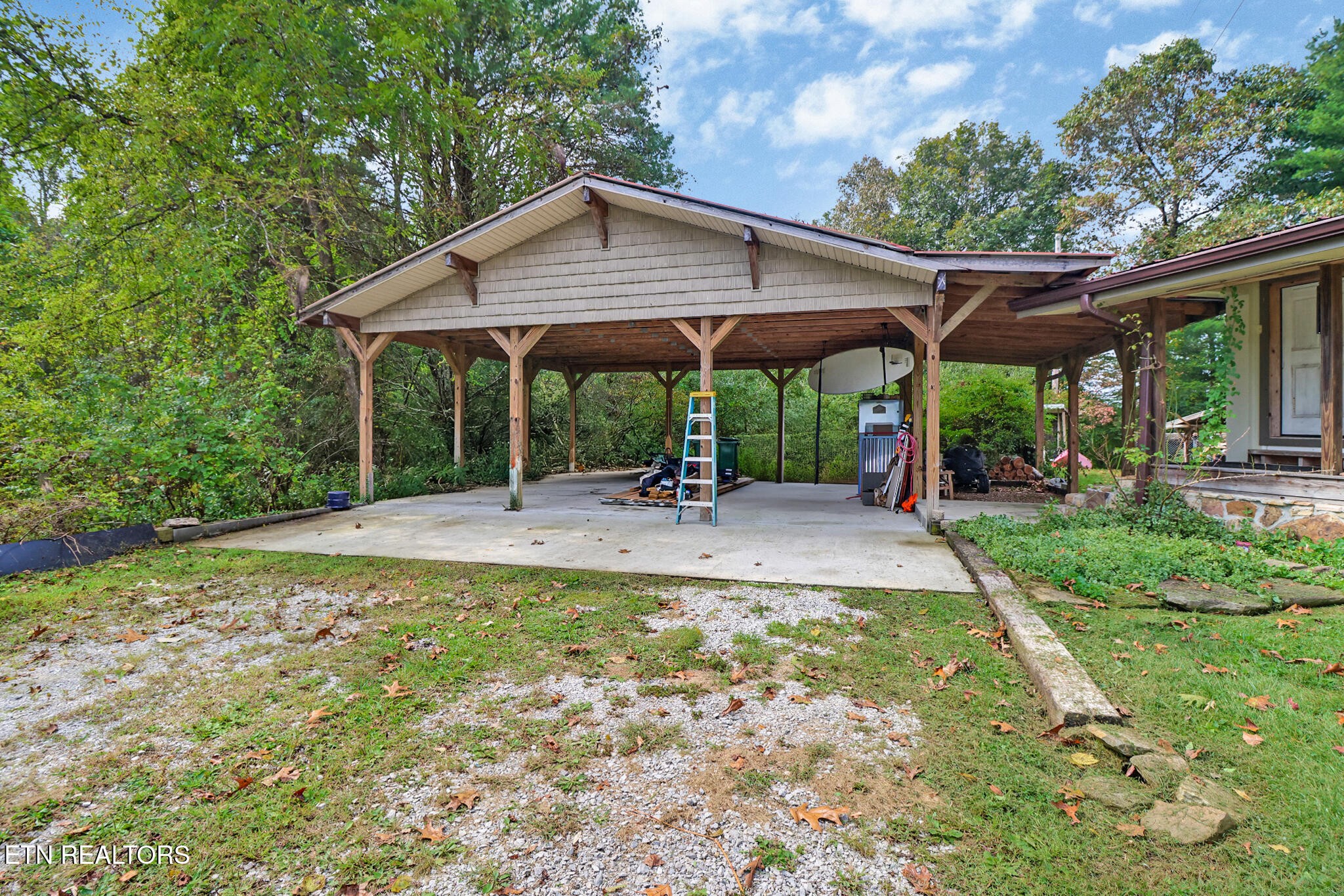 4676 Rugby Pike Allardt, TN 38504 - Photo 24 of 50 a backyard of a house with table and chairs under an umbrella