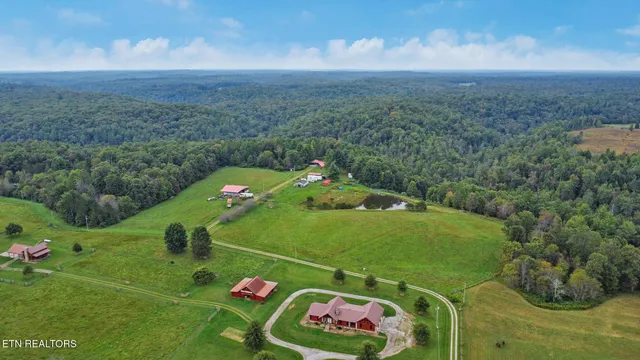 a backyard of a house with a yard and outdoor seating