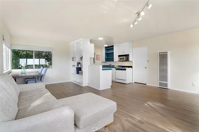 a living room with furniture and kitchen view