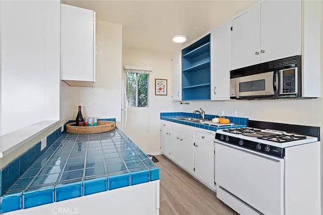 a kitchen with stainless steel appliances a stove a microwave and cabinets