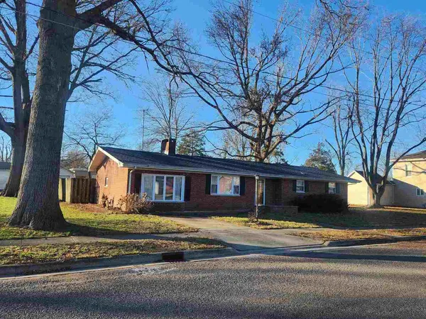 a view of a house with a large windows and a large tree