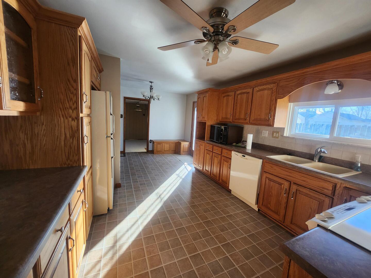 458 West Maple Street Nashville, IL 62263 - Photo 13 of 27 a view of a kitchen with a sink dishwasher a stove top oven a refrigerator with wooden cabinets and floor
