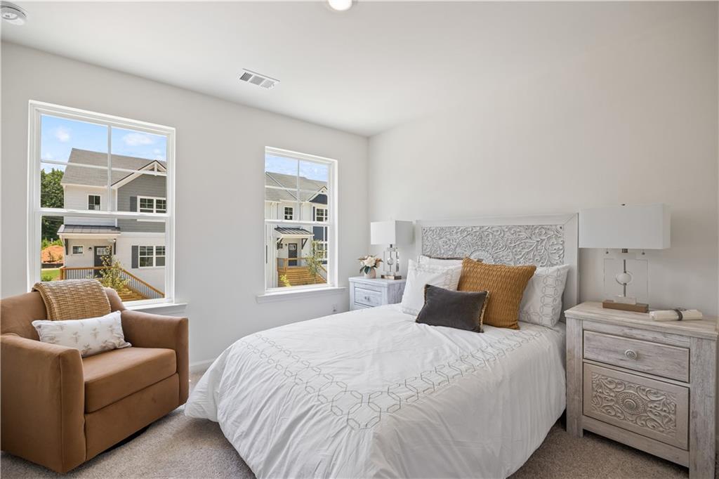 1567 Aiden Way, Unit 34 Conyers, GA 30013 - Photo 27 of 28 a bedroom with a bed and a couch