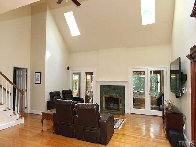 2504 Barton Ridge Court Raleigh, NC 27613 - Photo 3 of 25 Enjoy the large family room with hardwood floors, ceiling fan & a great view to the screened in porch.. Den/Family/Great Room