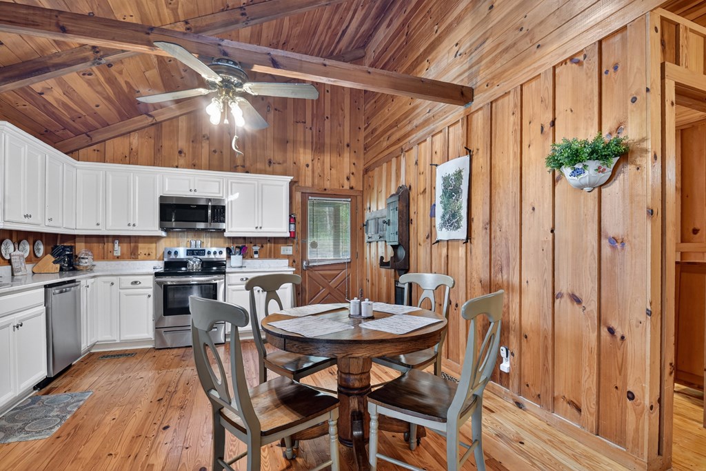 421 Salem Valley Road Mineral Bluff, GA 30559 - Photo 21 of 33 a view of a dining room with furniture and chandelier