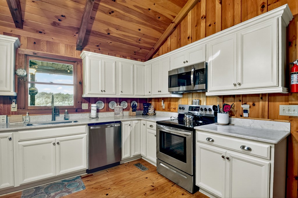 421 Salem Valley Road Mineral Bluff, GA 30559 - Photo 24 of 33 a kitchen with a sink stove and cabinets