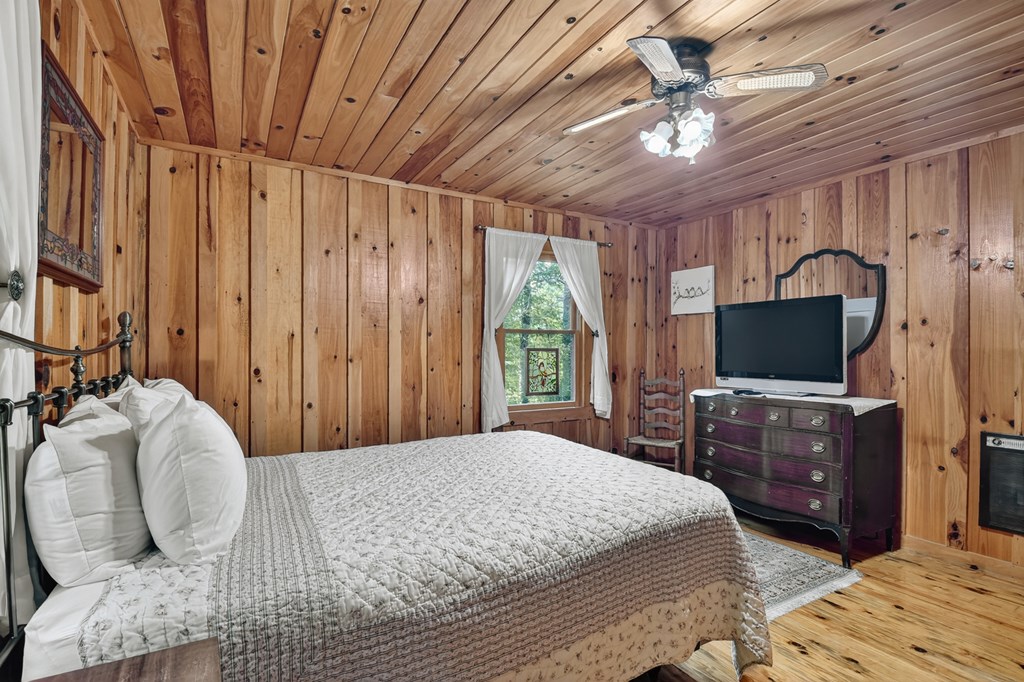 421 Salem Valley Road Mineral Bluff, GA 30559 - Photo 30 of 33 a bedroom with a bed and a flat screen tv