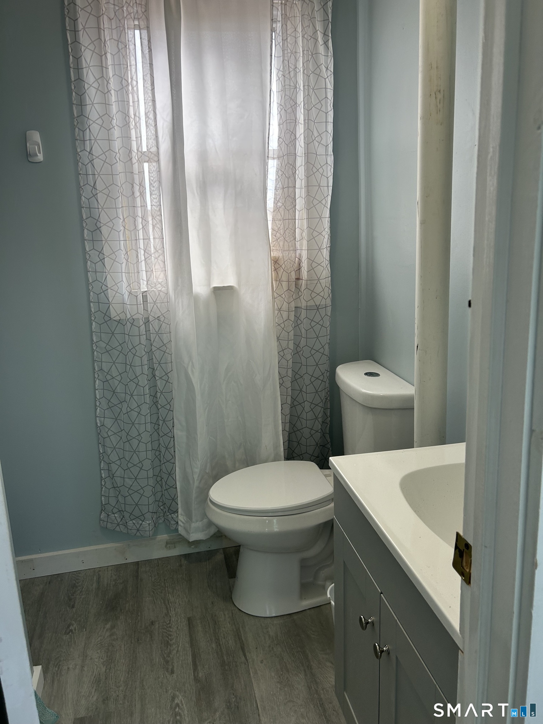 92 Caroline Road East Haven, CT 06512 - Photo 11 of 20 a white toilet sitting next to a bathroom sink