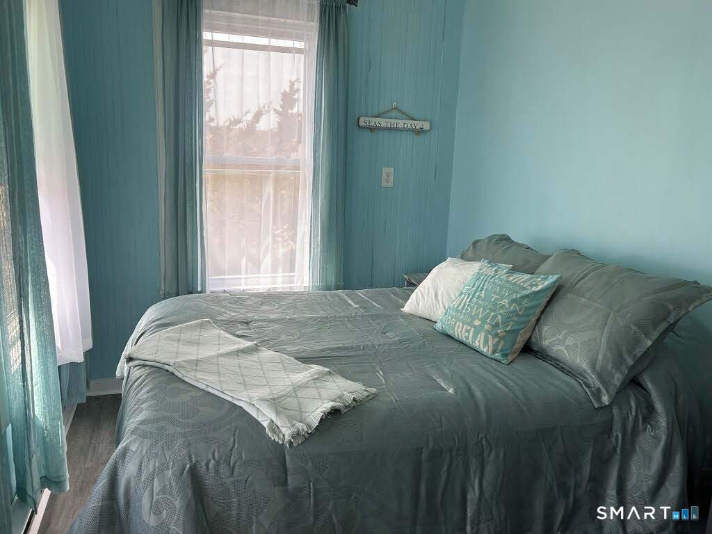 92 Caroline Road East Haven, CT 06512 - Photo 14 of 20 a bed sitting in a bedroom next to a window