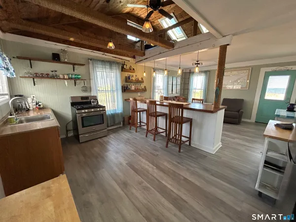 a view of a dining room with furniture window and wooden floor