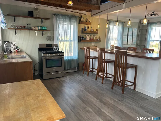 a kitchen with stainless steel appliances a stove a sink and a refrigerator