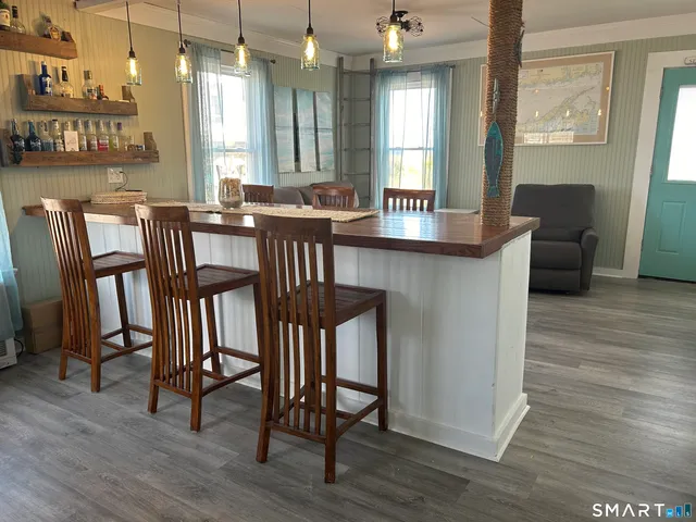 a view of a a dining room with furniture window and wooden floor