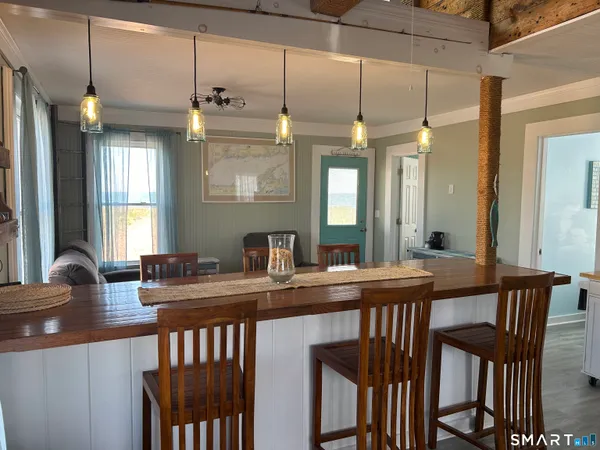 a kitchen with a table chairs and a chandelier
