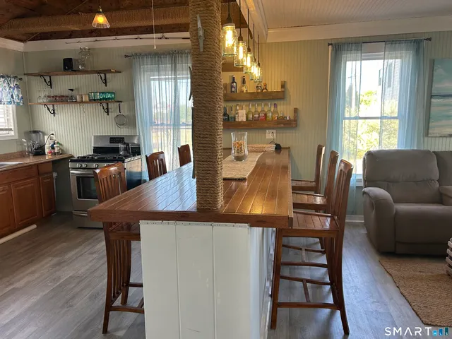 a view of a dining room with furniture window and wooden floor