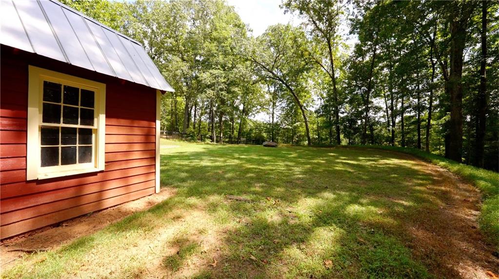 2425 Birmingham Road Alpharetta, GA 30004 - Photo 48 of 75 a view of a backyard with a plants and large trees