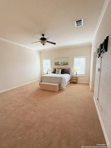 a living room with furniture and a ceiling fan