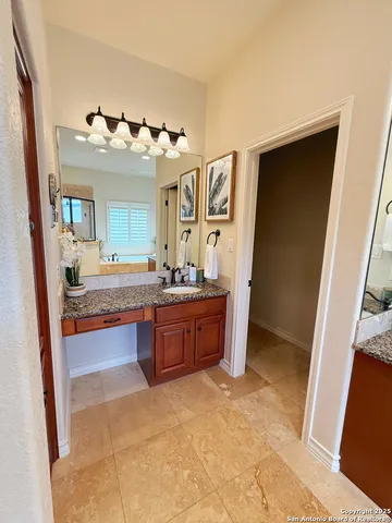 a bathroom with a tub sink and mirror