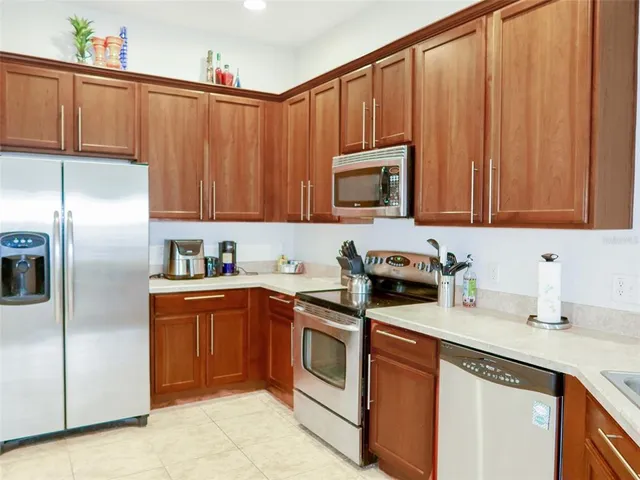 a kitchen with stainless steel appliances granite countertop a refrigerator sink and cabinets