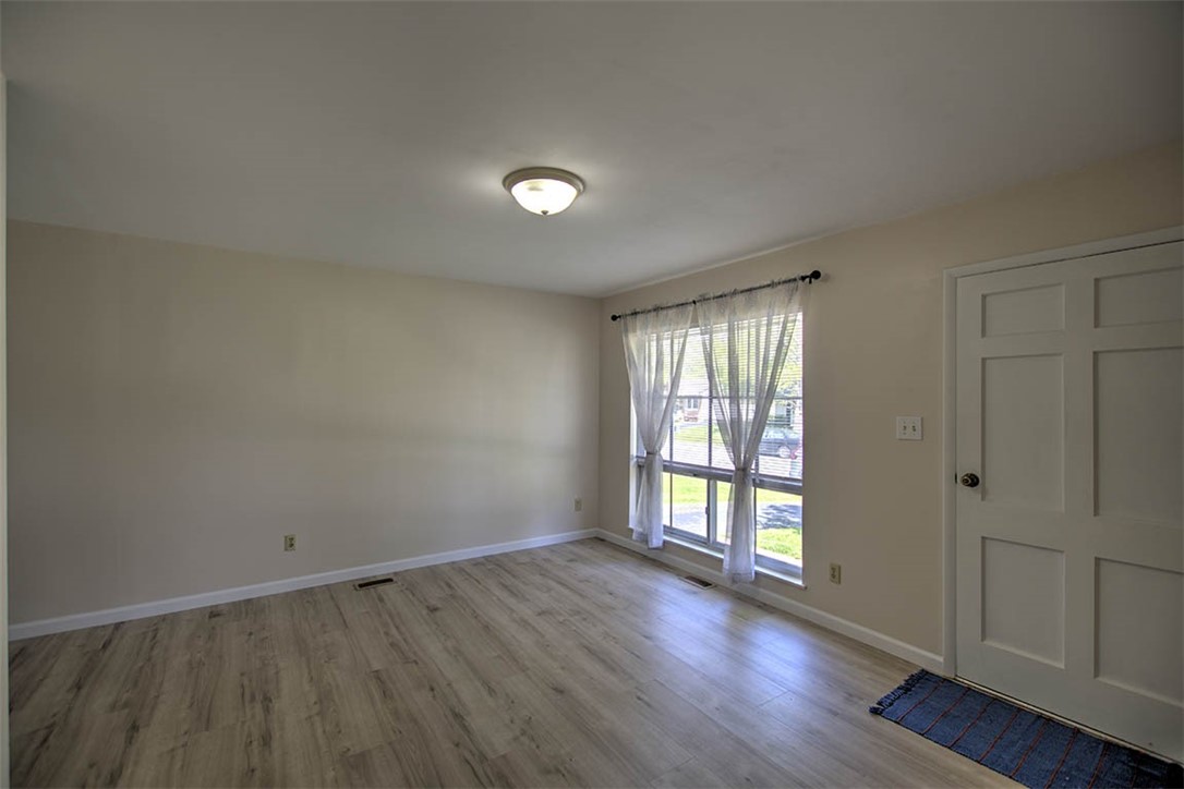 2007 Windsor Road Decatur, IL 62521 - Photo 9 of 26 an empty room with wooden floor and windows