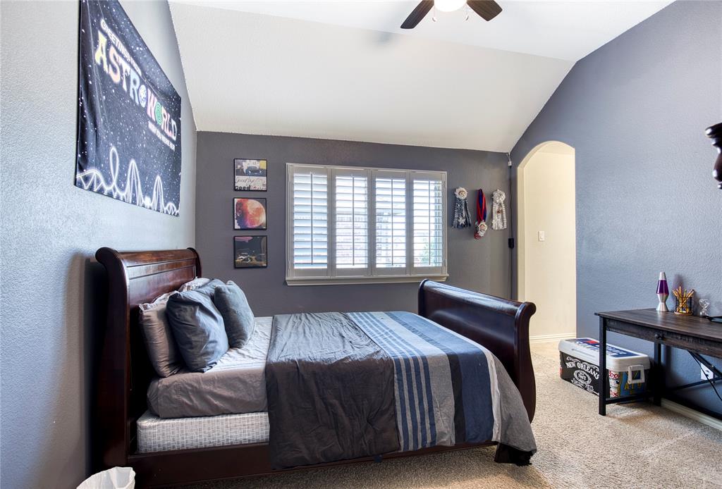 1552 Saddle Tree Road Frisco, TX 75036 - Photo 30 of 40 One of 3 large bedrooms upstairs featuring a textured wall, carpet, lofted ceiling, arched walkways, a ceiling fan and a private sink area