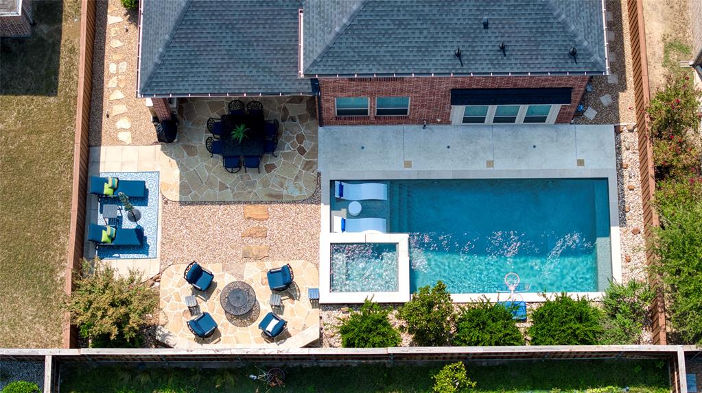 1552 Saddle Tree Road Frisco, TX 75036 - Photo 3 of 40 Amazing Backyard featuring Pool/Spa, Outdoor seating and living space, Covered patio and built in grill. Low maintenance yard with professional landscaping and plenty of privacy!