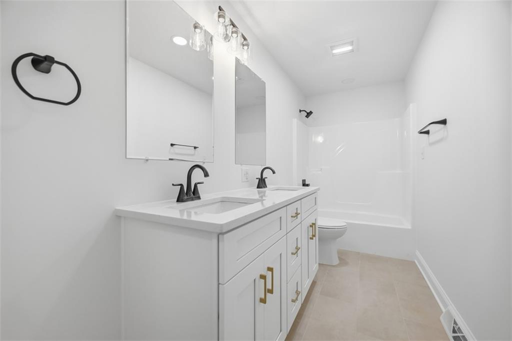 625 Manifold Road Washington, PA 15301 - Photo 17 of 46 a bathroom with a double vanity sink and a mirror