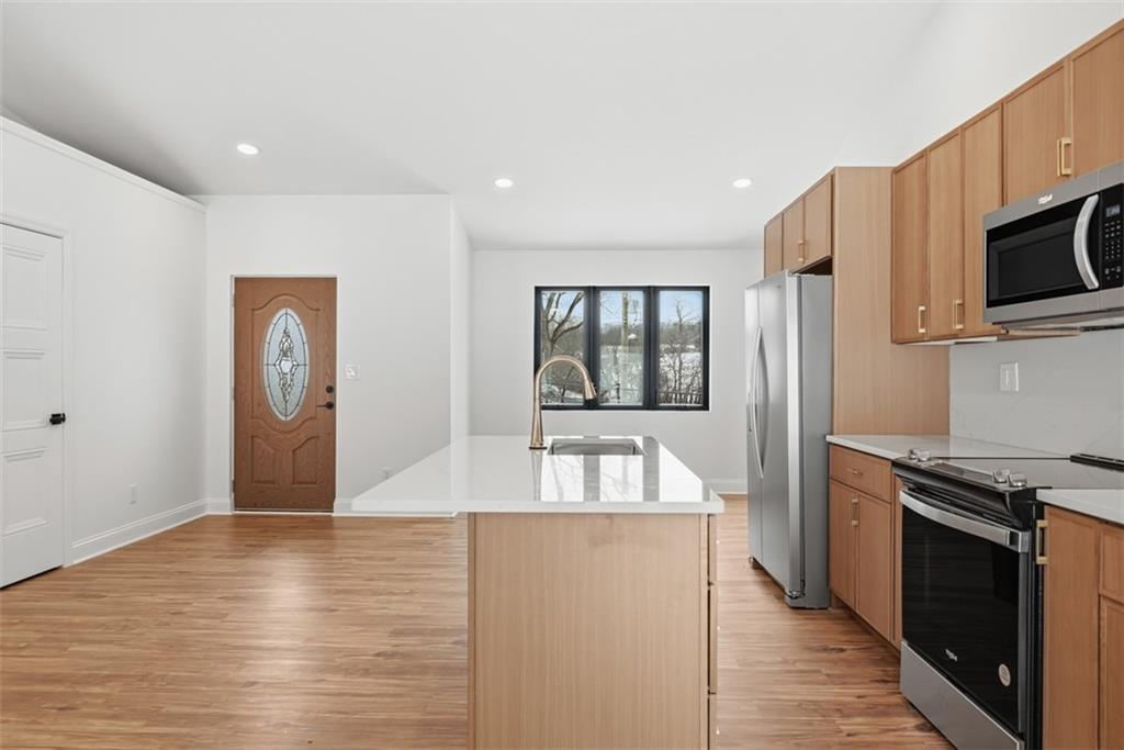 625 Manifold Road Washington, PA 15301 - Photo 10 of 46 a kitchen with stainless steel appliances granite countertop a refrigerator a stove oven a sink with island and chairs