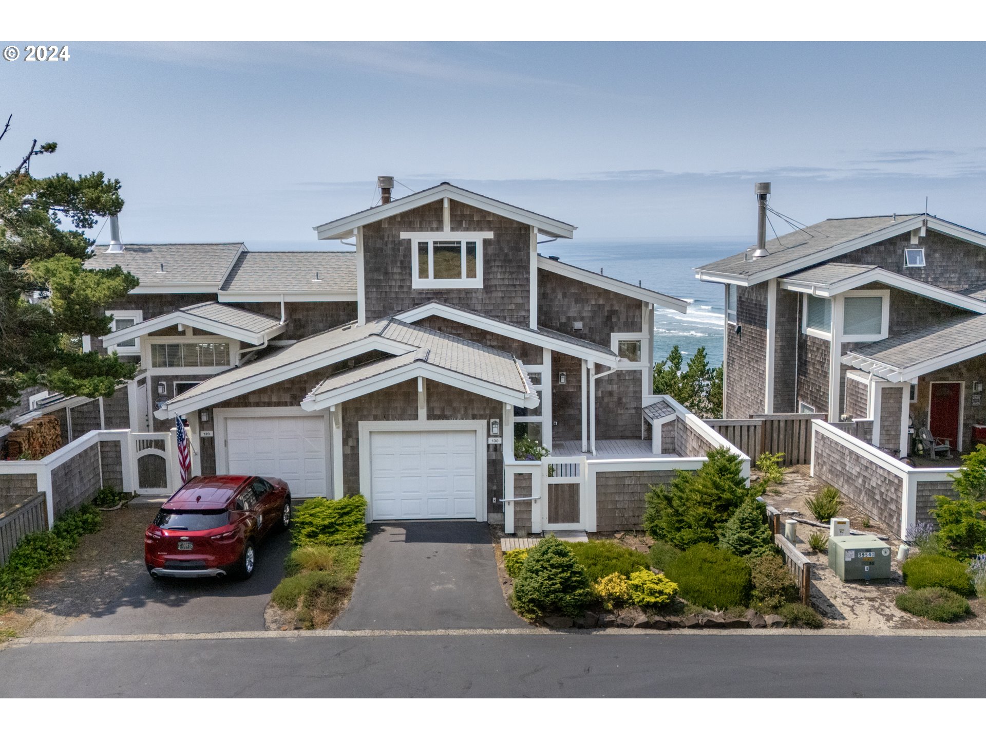 a front view of a house with a garden