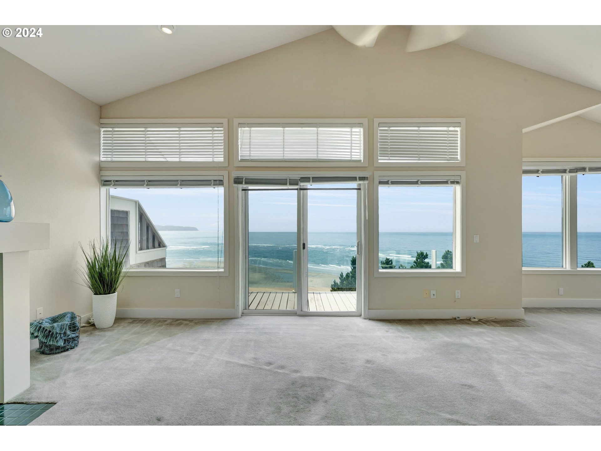 130 Capes Drive Oceanside, OR 97141 - Photo 11 of 48 a view of an empty room with wooden floor and a window