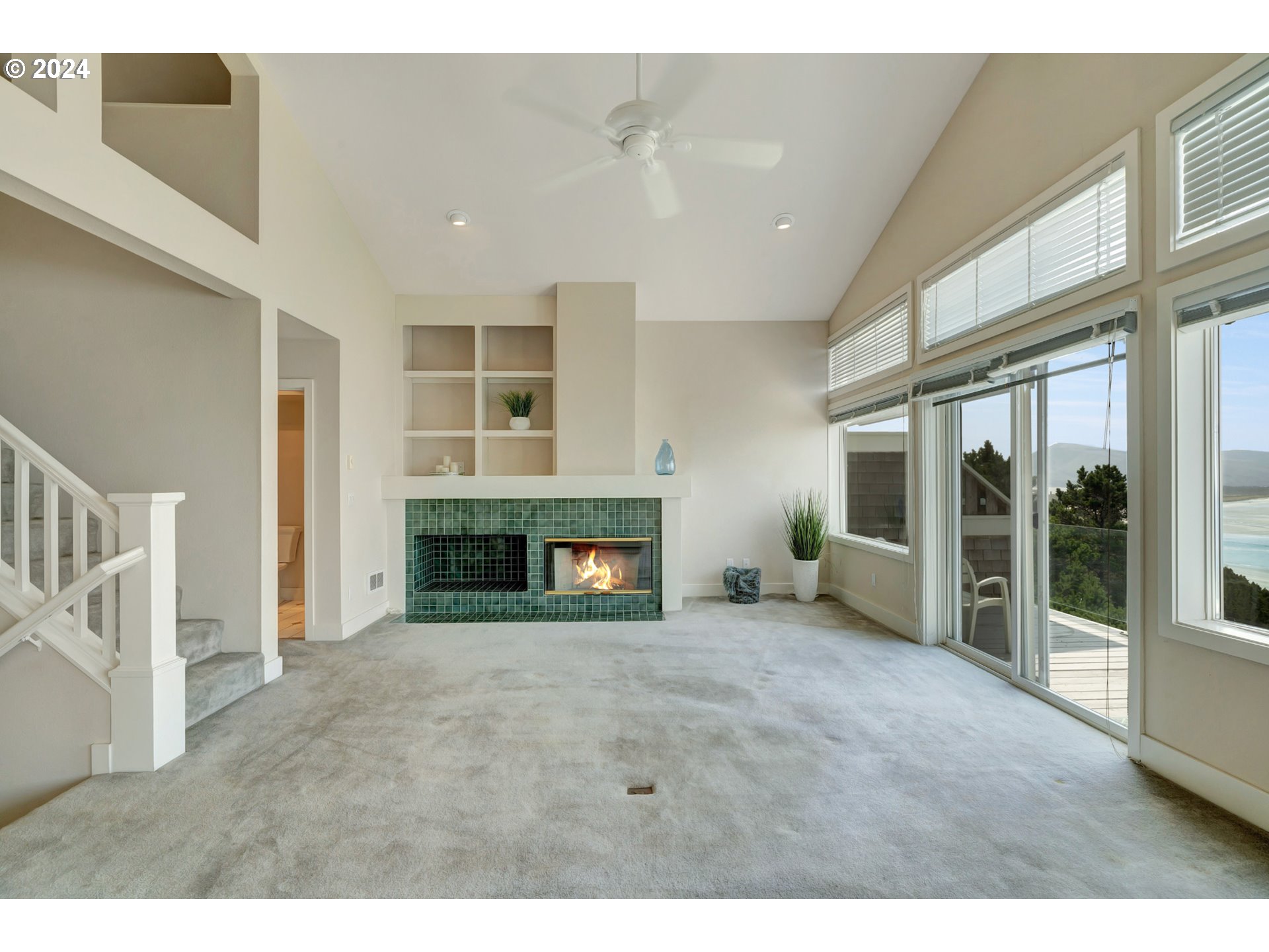 130 Capes Drive Oceanside, OR 97141 - Photo 14 of 48 a view of an empty room with a fireplace and a window