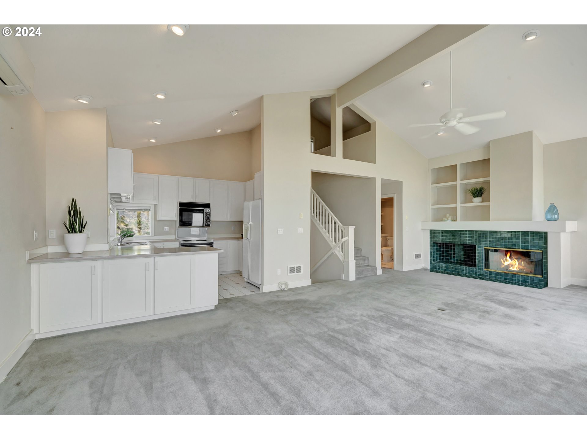 130 Capes Drive Oceanside, OR 97141 - Photo 15 of 48 a view of kitchen with cabinets and fireplace