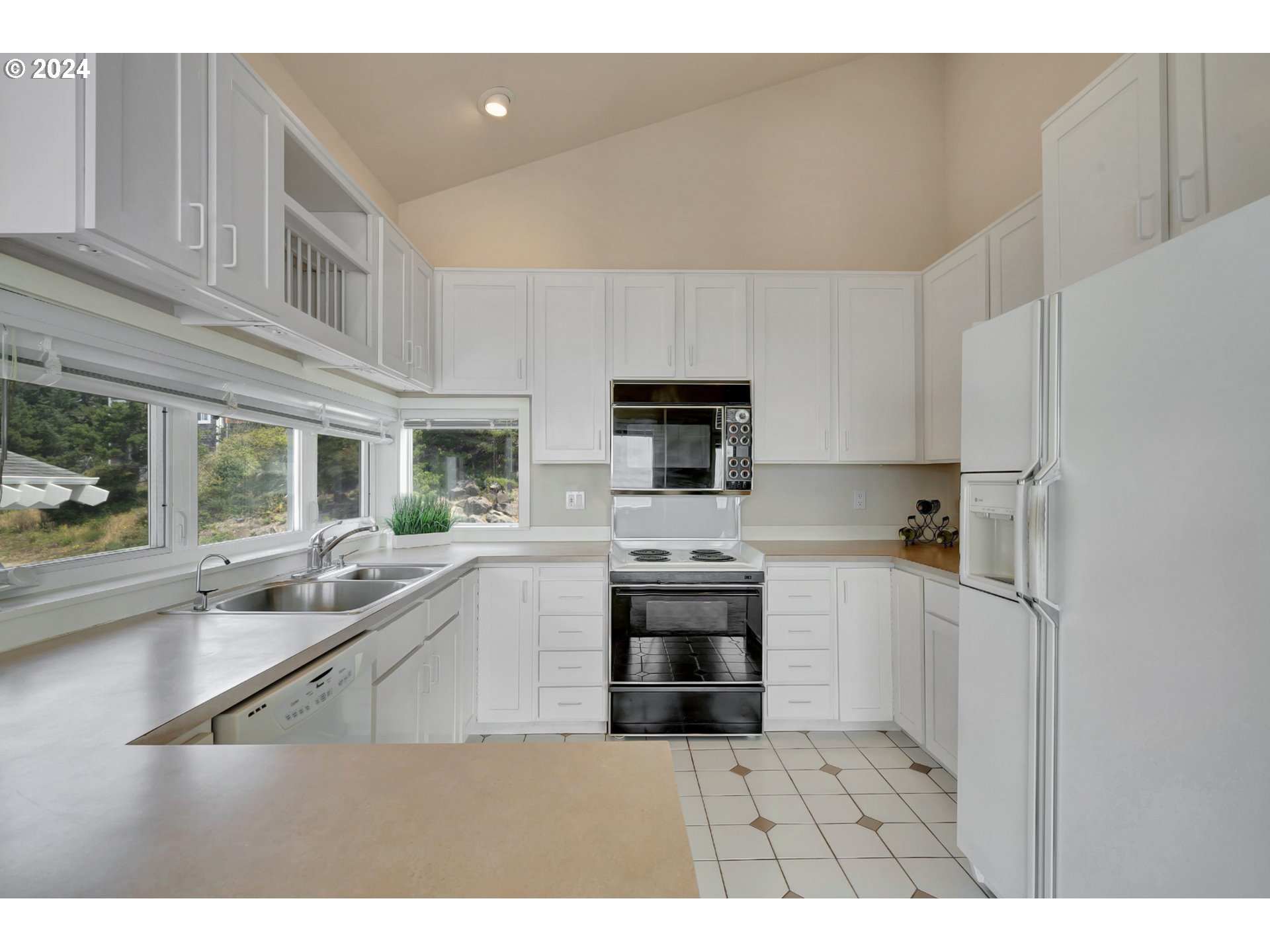 130 Capes Drive Oceanside, OR 97141 - Photo 18 of 48 a kitchen with stainless steel appliances a sink stove and refrigerator