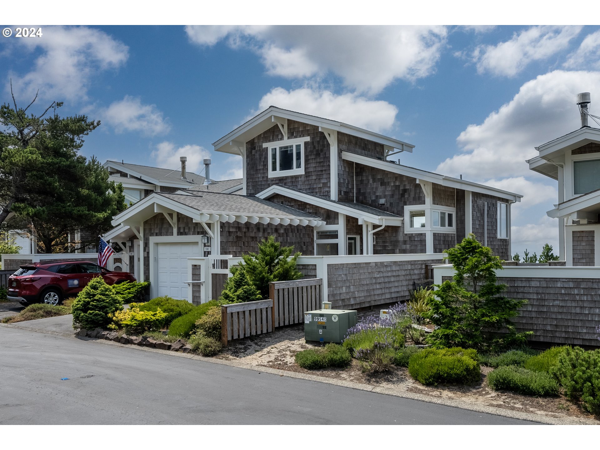 130 Capes Drive Oceanside, OR 97141 - Photo 3 of 48 a front view of a house with a garden