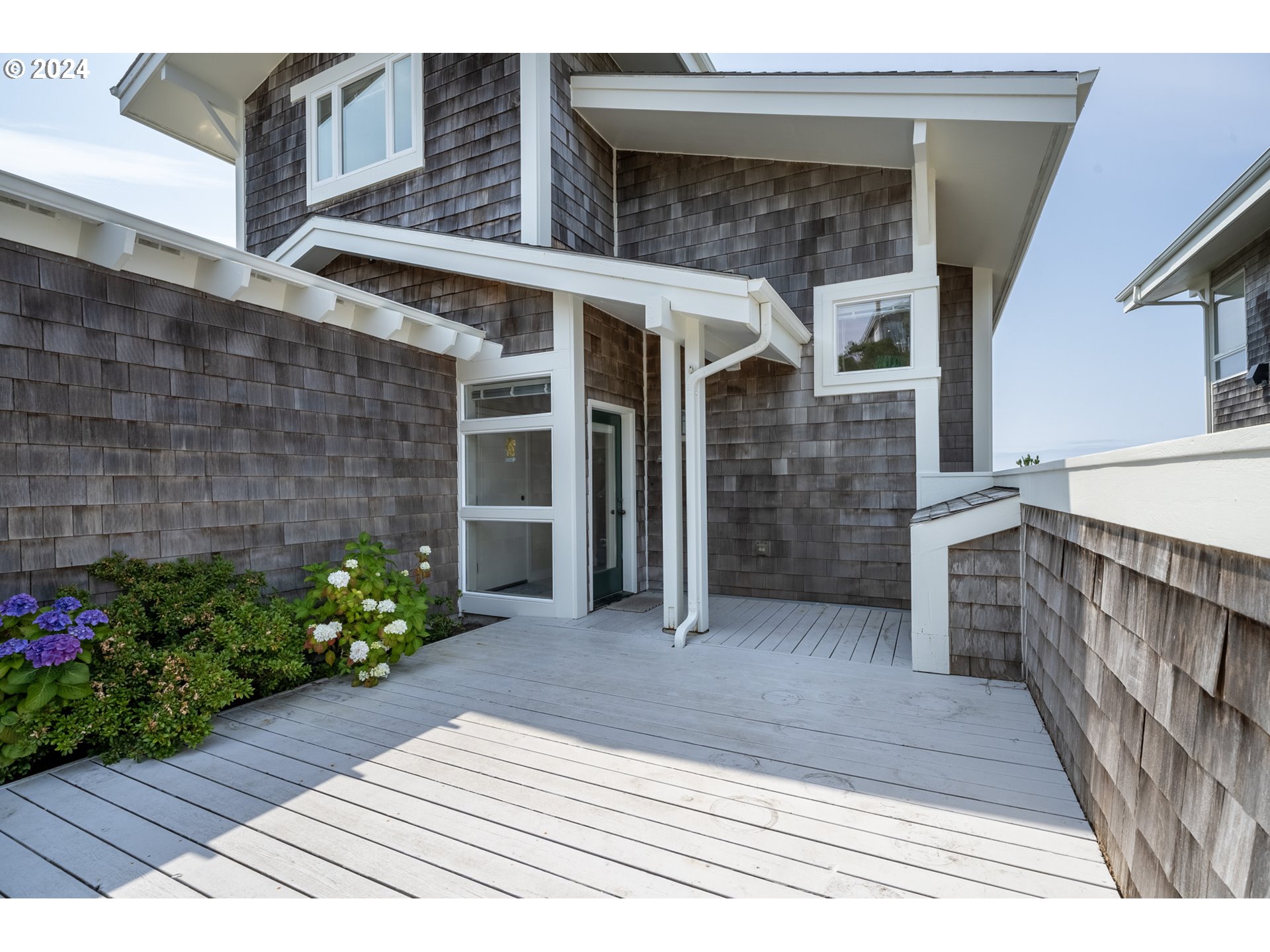130 Capes Drive Oceanside, OR 97141 - Photo 8 of 48 a view of a house with entryway and flower plants