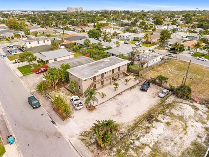 an aerial view of residential houses with outdoor space and swimming pool